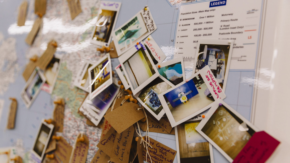 Multiple polaroid photos attached to a UK map