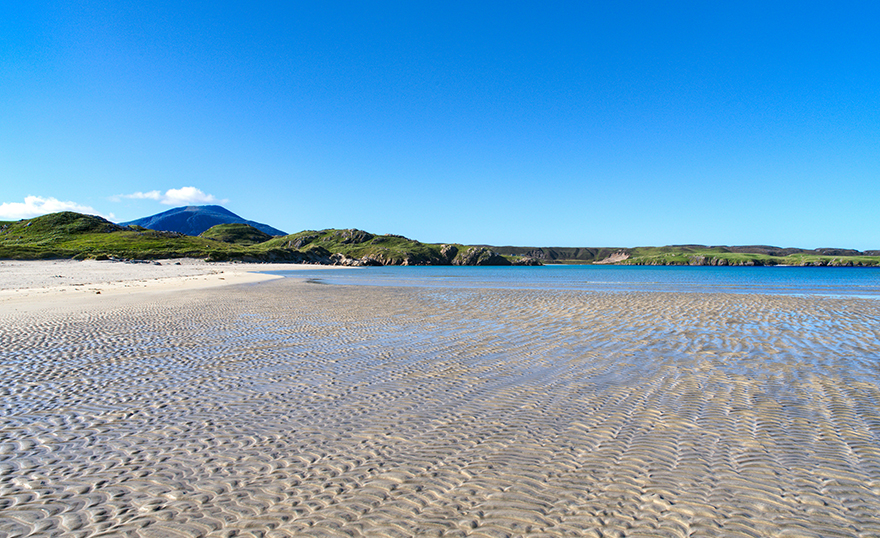 Beach with rippling sand under clear water